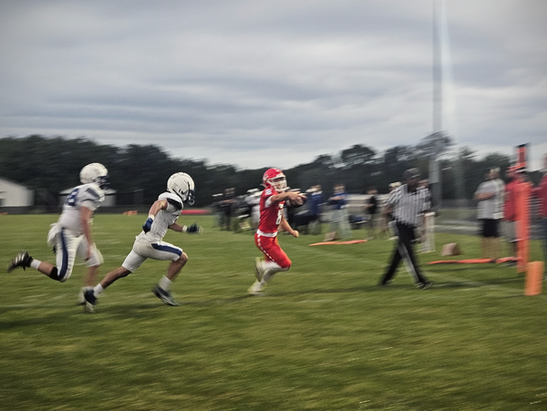 SOBO player running into the end zone with the ball being chased down by two Christian Life Eagles.