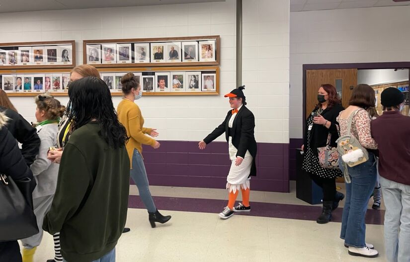 Actor in tuxedo costume playing a penguin in Madagascar Jr shakes hands in lobby  at Hononegah Performing Arts Center in Rockton IL