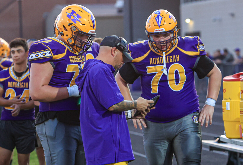 Jacob and Maximus Benson talk to a shorter coach