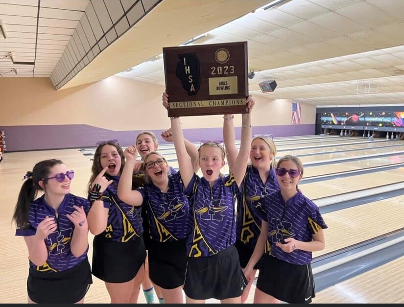 Girls bowling team with trophy plaque