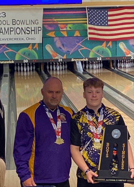 Charlie Hunt and his coach poses for pictures with his 2023 U.S. Bowling National Championship trophy