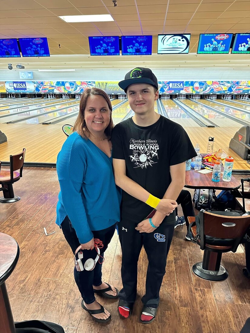 Mom and winning son at bowling alley