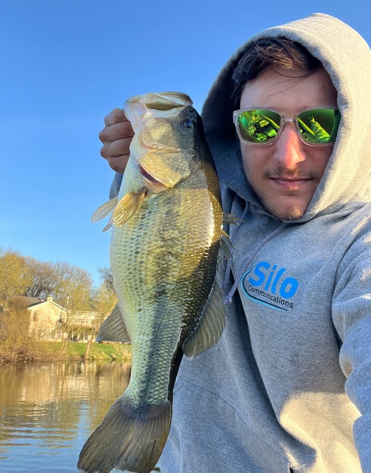 Mason Lambert showing off his latest bass caught for the Hononegah Bass Fishing Team