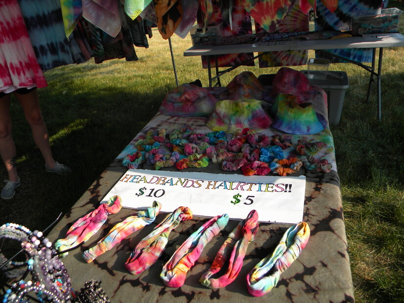 Tie-dyed headbands and scarves for sale on table