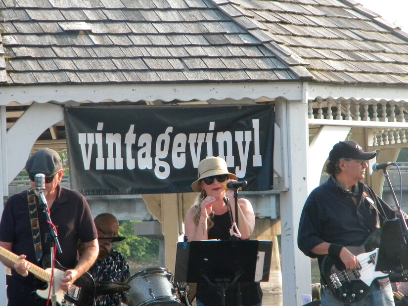 Vintage Vinyl band members performing in front of white gazebo