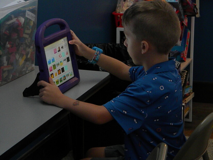 child coding on a tablet