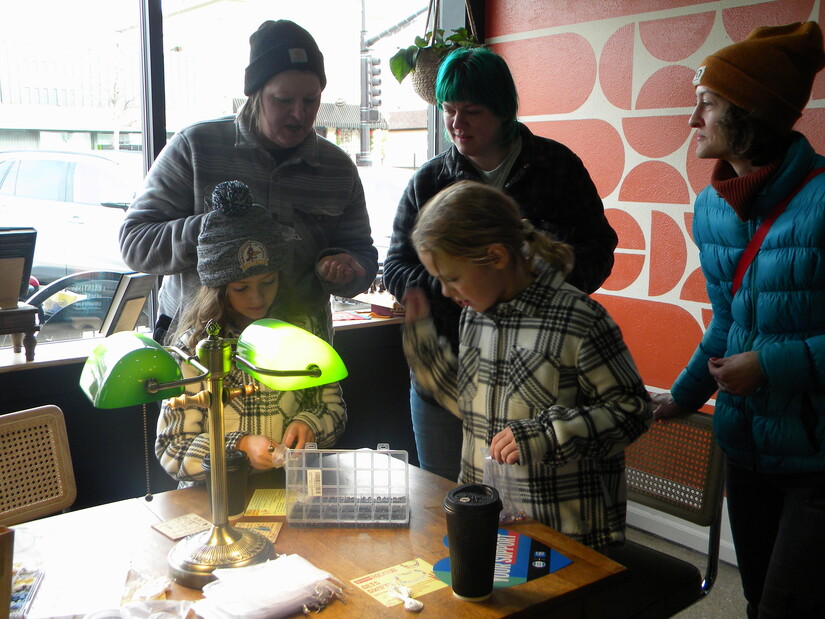 Picking out charms at Inkwell Books & Threads