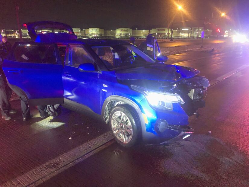 Blue car with front end smashed at night near shops on West Lane Road in Machesney Park, IL