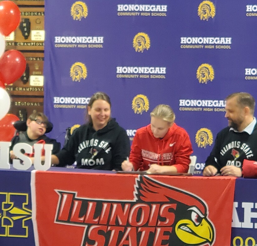 High school athlete with backdrop, table and parents