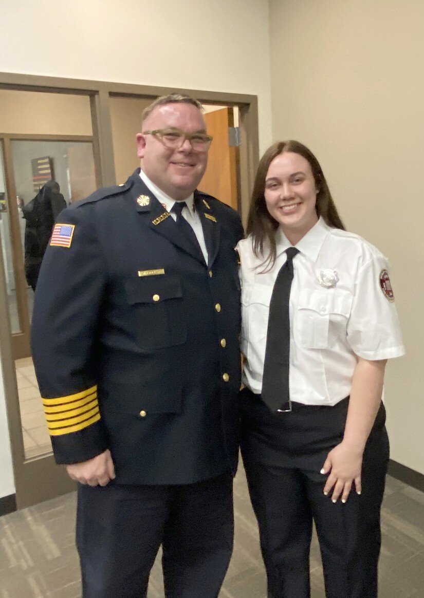 Male fire chief with female firefighter wearing tie