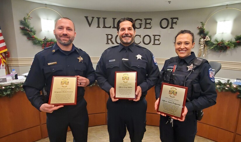 Three police officers with certificates