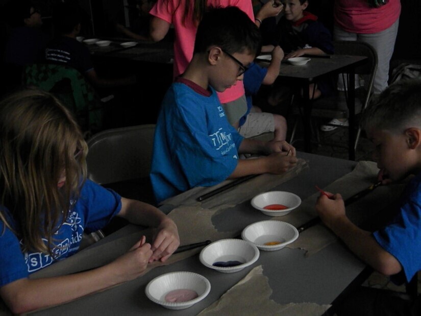 kids painting sticks as 'magic wands'