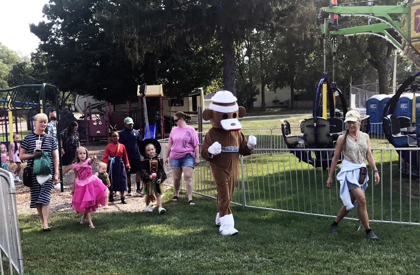 Midway Village Sock Monkey leads the Kiddie Parade through Leland Park in Roscoe, Illinois